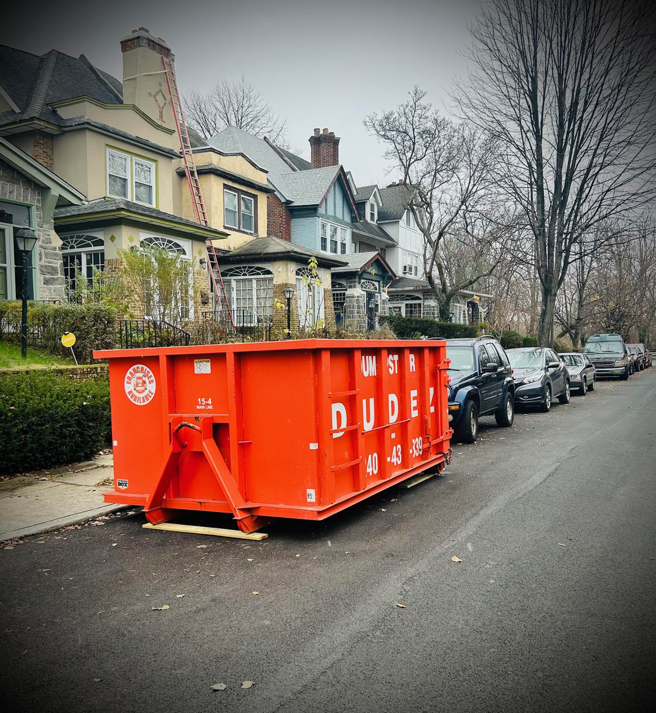 
				A 20 yard dumpster in front of a residential home.
			