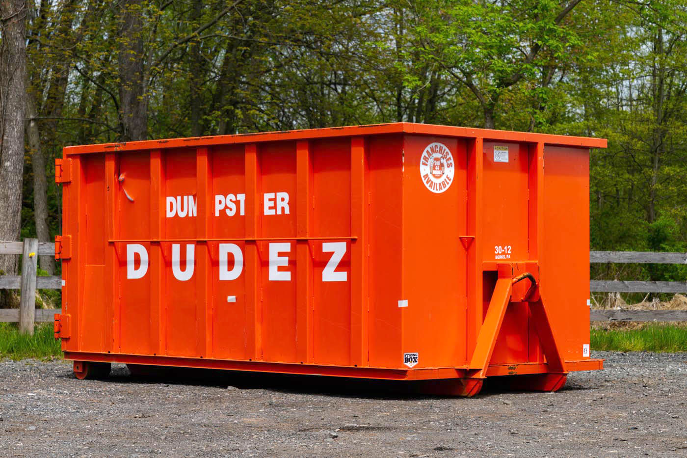 A Dumpster Dudez team member standing next to a 25 yard dumpster.