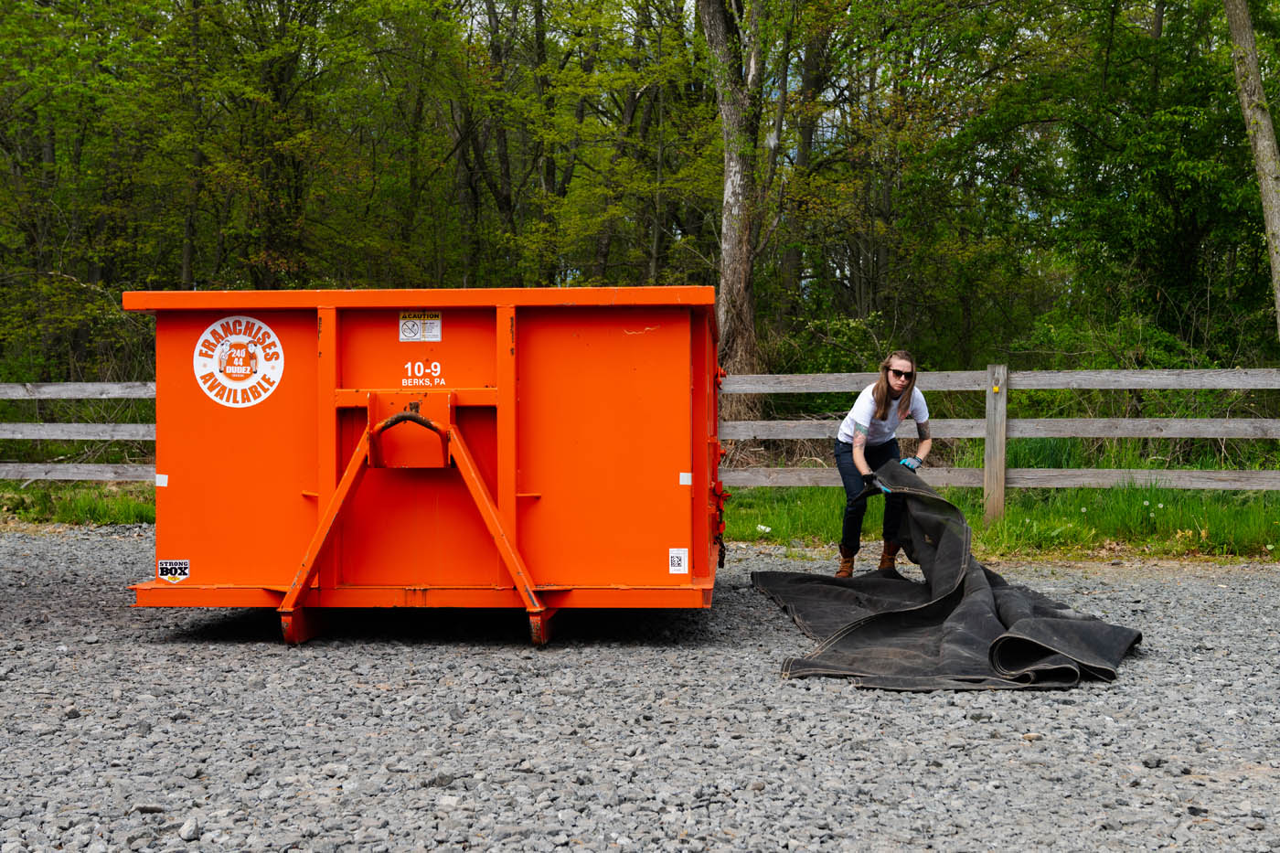 Dumpster Dudez employee next to one of our dumpster - a perfect solution for waste management.