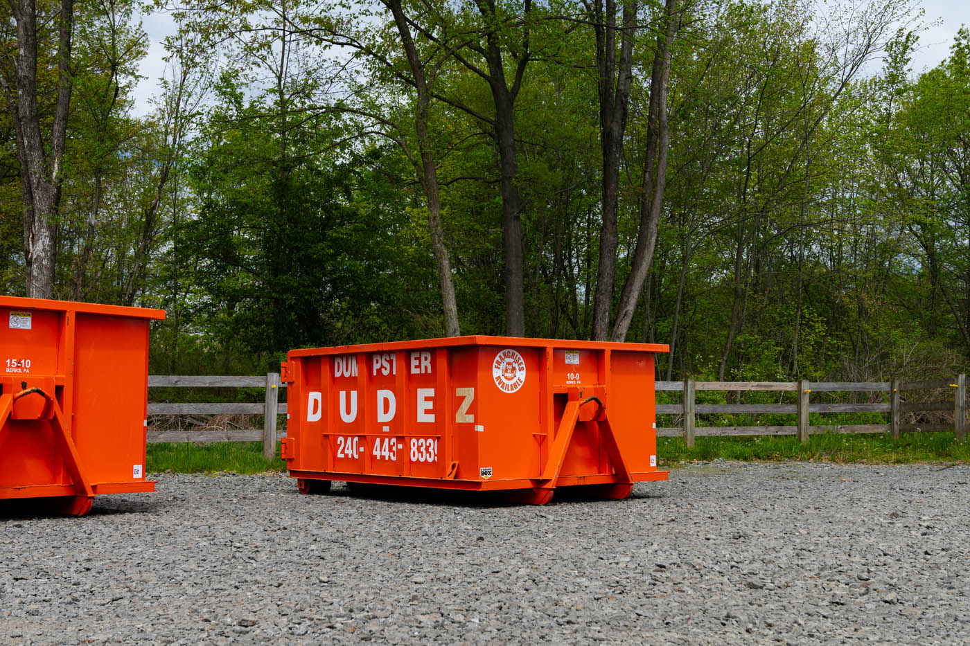A Dumpster Dudez orange dumpster - contact us today for trash dumpster rental tips!