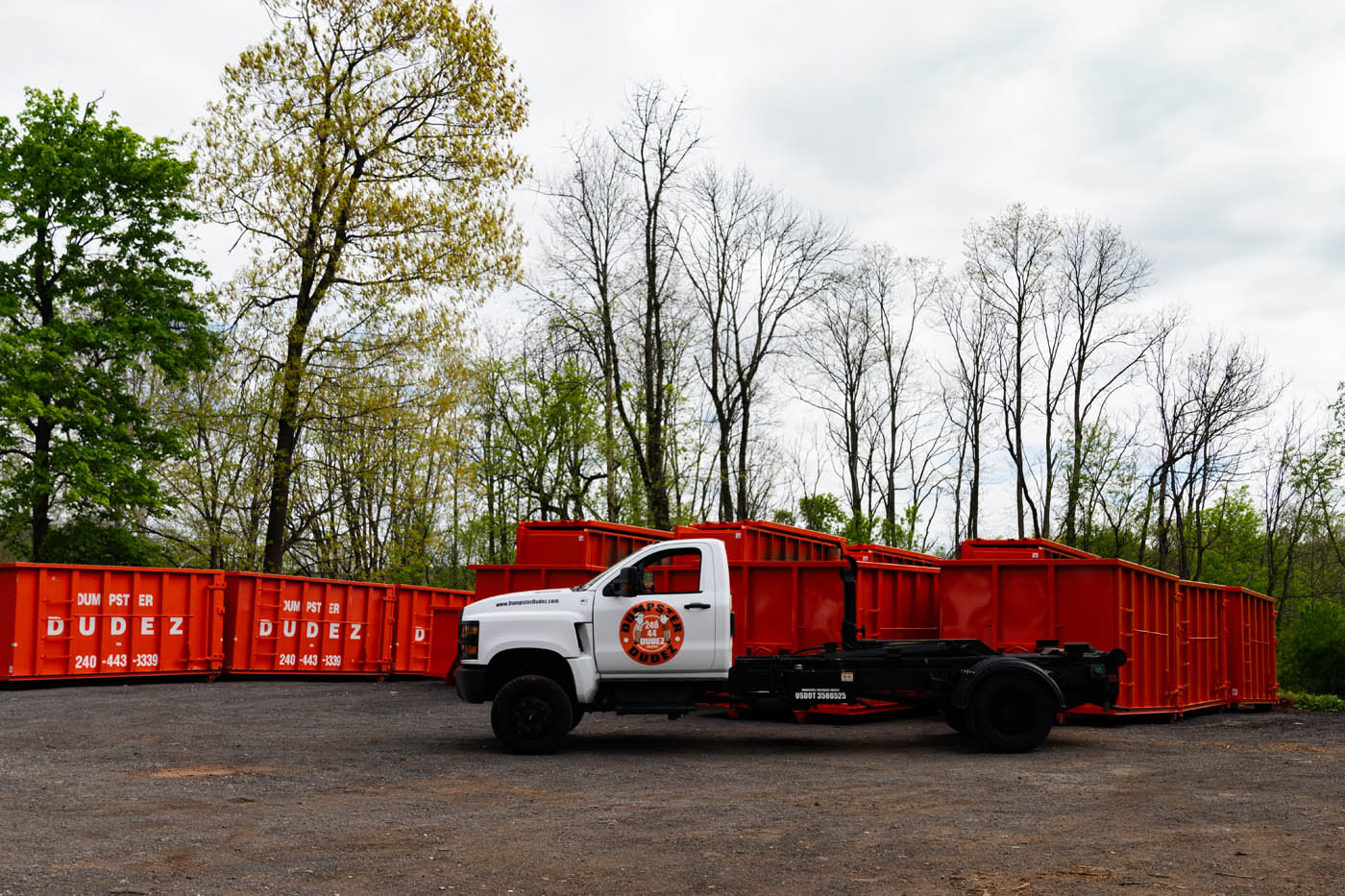 A Boise / Nampa 10 yard dumpster rental truck in the woods.