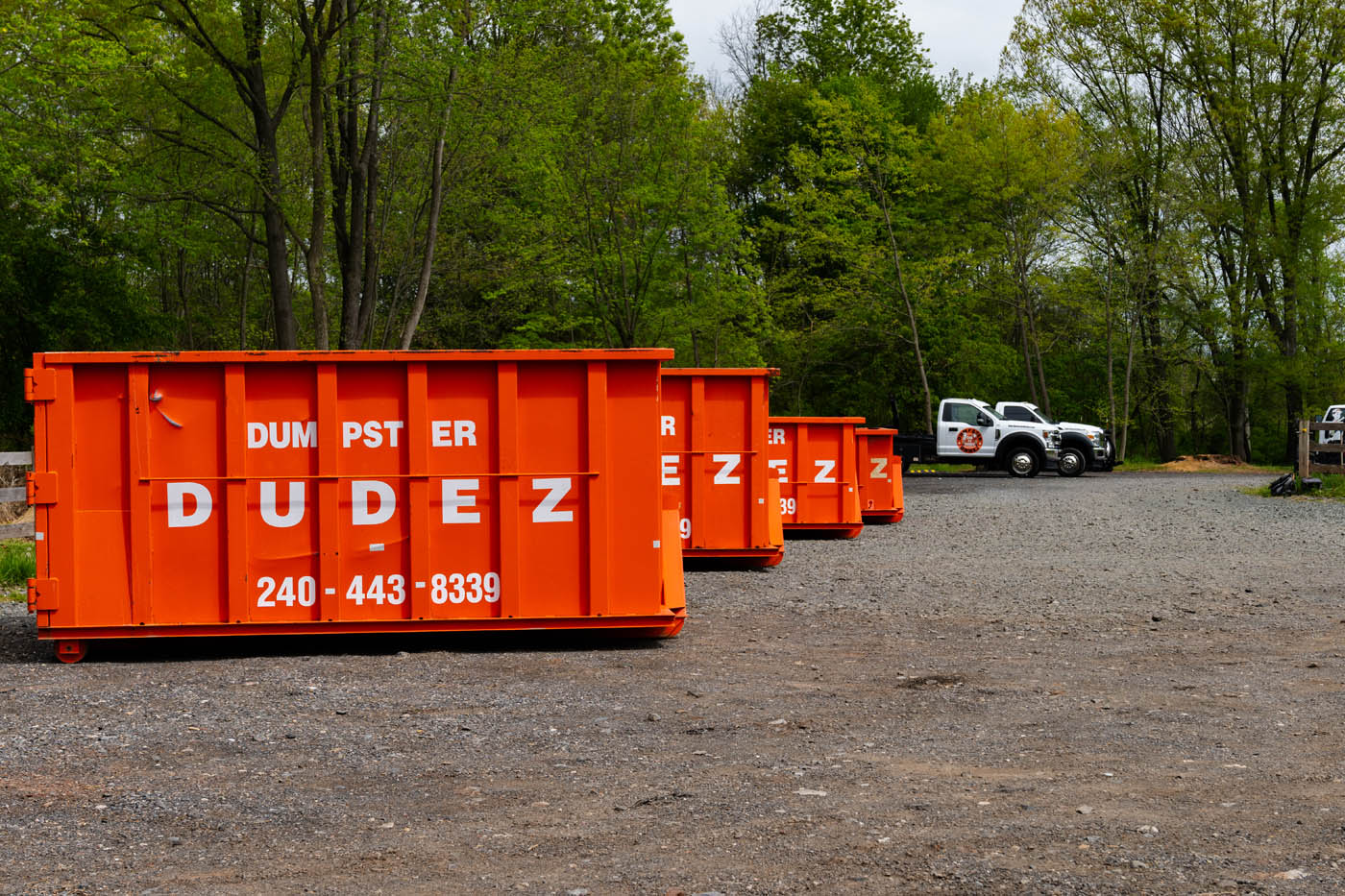 Multiple dumpster rentals lined up in a row - learn how a Fayetteville–Springdale–Rogers construction dumpster from Dumpster Dudez can benefit your site.