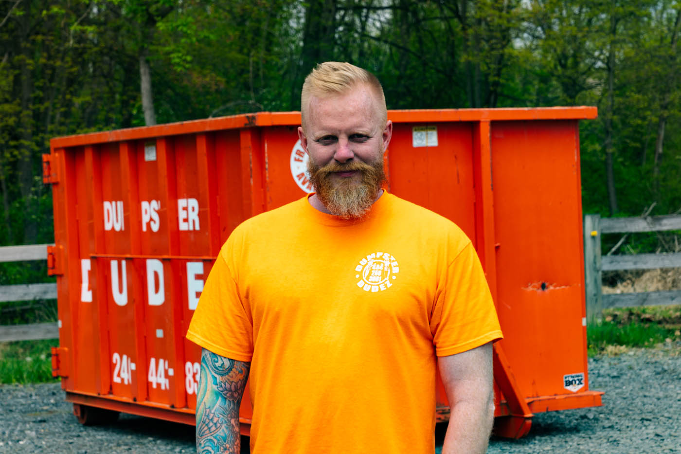 
				Dumpster Dudez Acadiana founder standing in front of a Lafayette / Acadiana roll off dumpster rental.
			