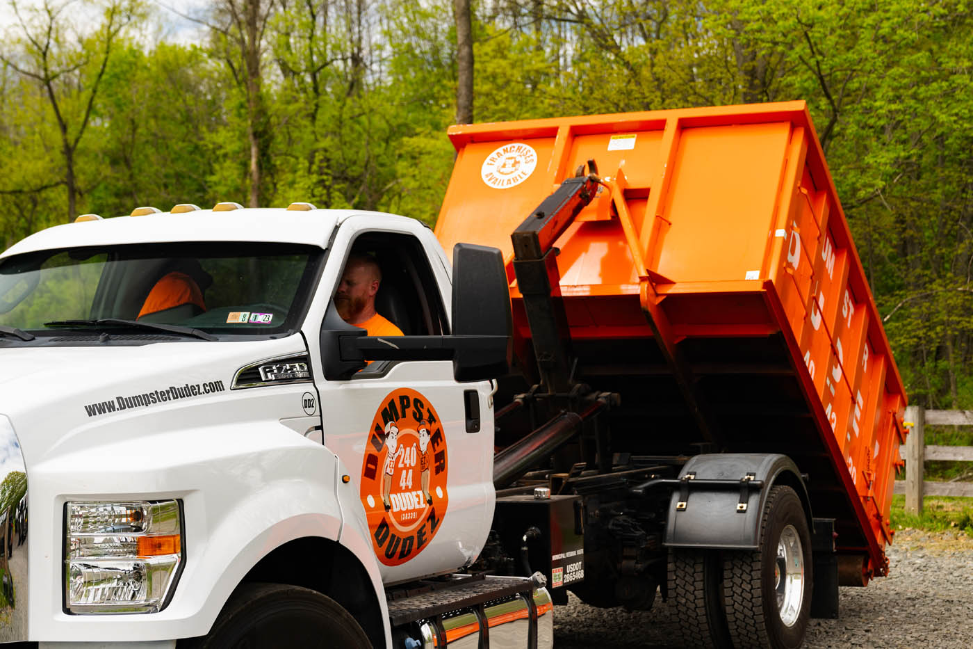 
		A Dumpster Dudez truck pulling a rental dumpster.
	