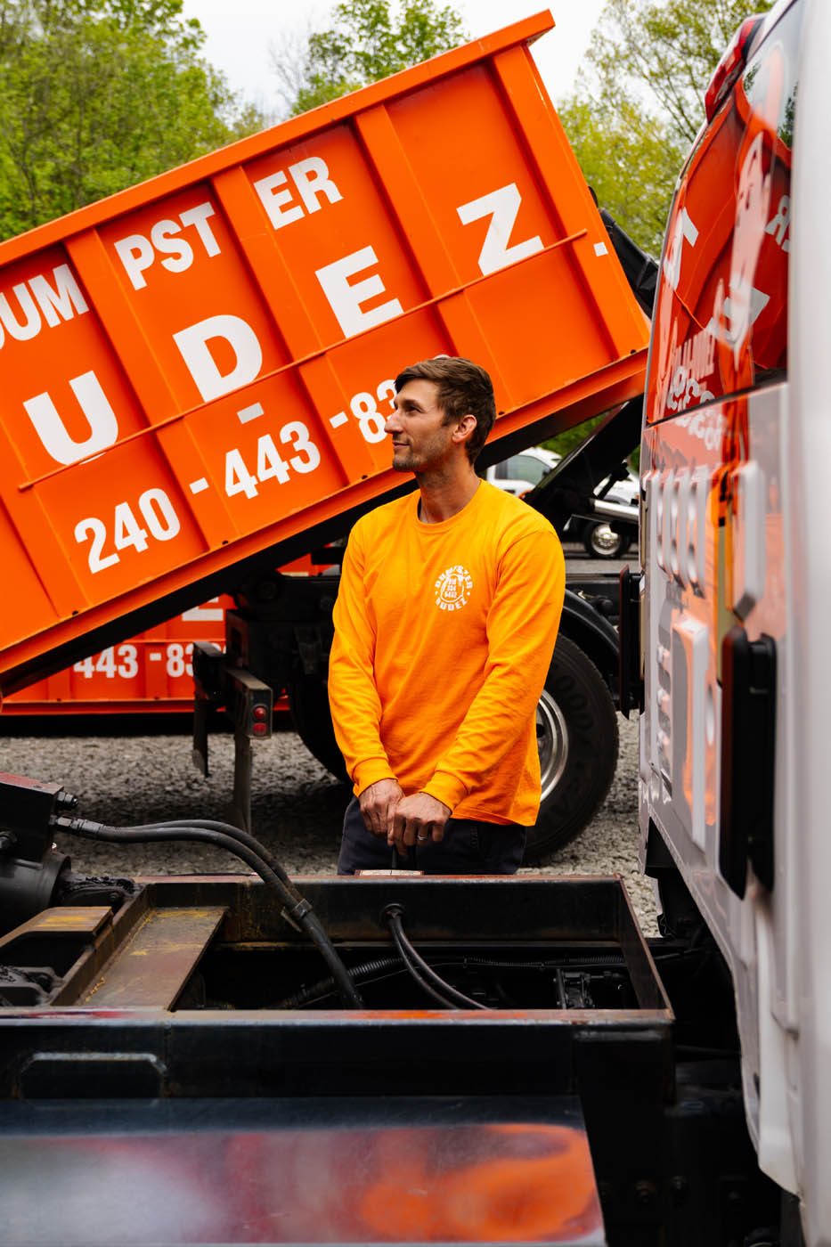 A Dumpster Dudez Acadiana corporate member working on a roll off dumpster.