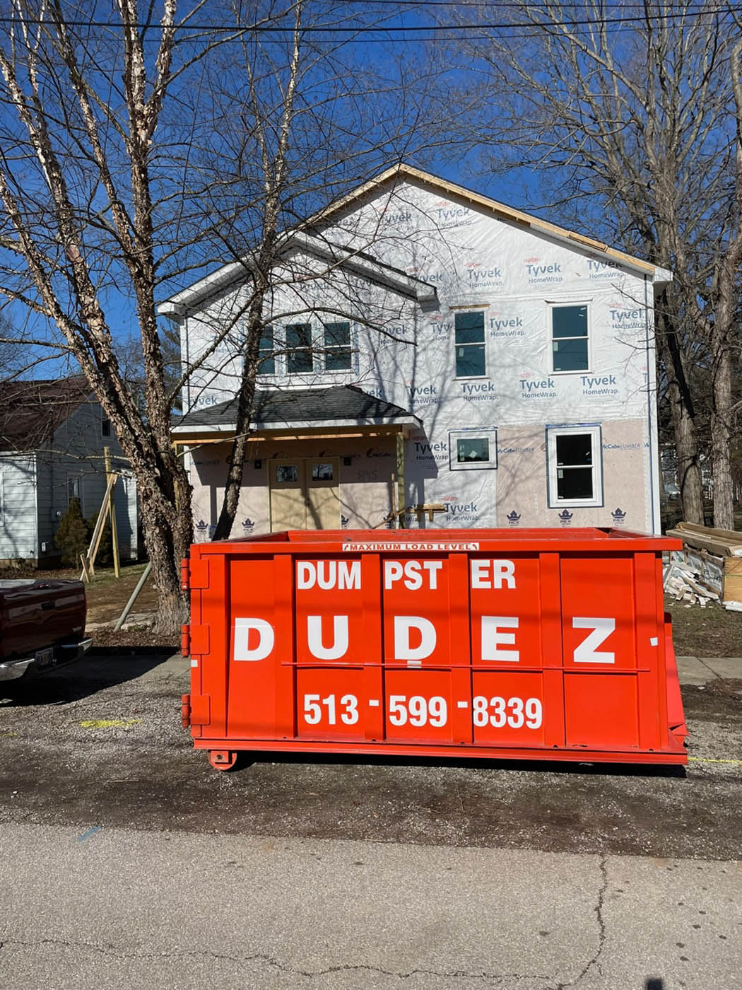 
A home in the process of construction using one of Dumpster Dudez's commercial dumpster rental.			