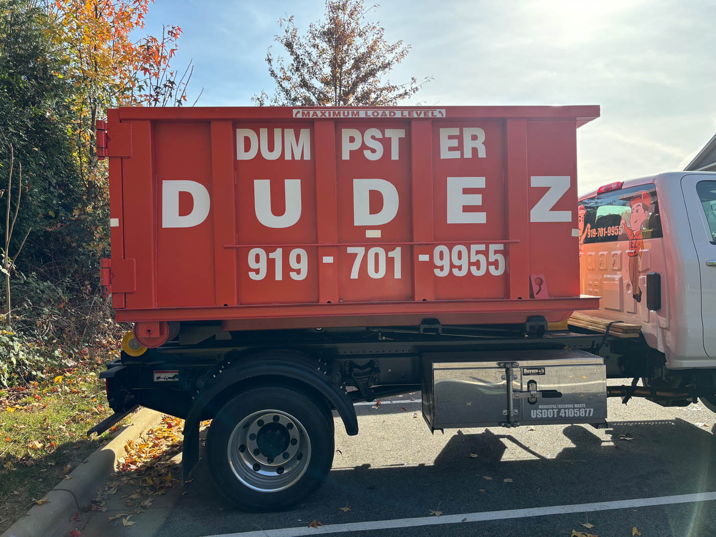 An orange Dumpster Dudez dumpster ready to provide Fayetteville–Springdale–Rogers junk haul away services.
