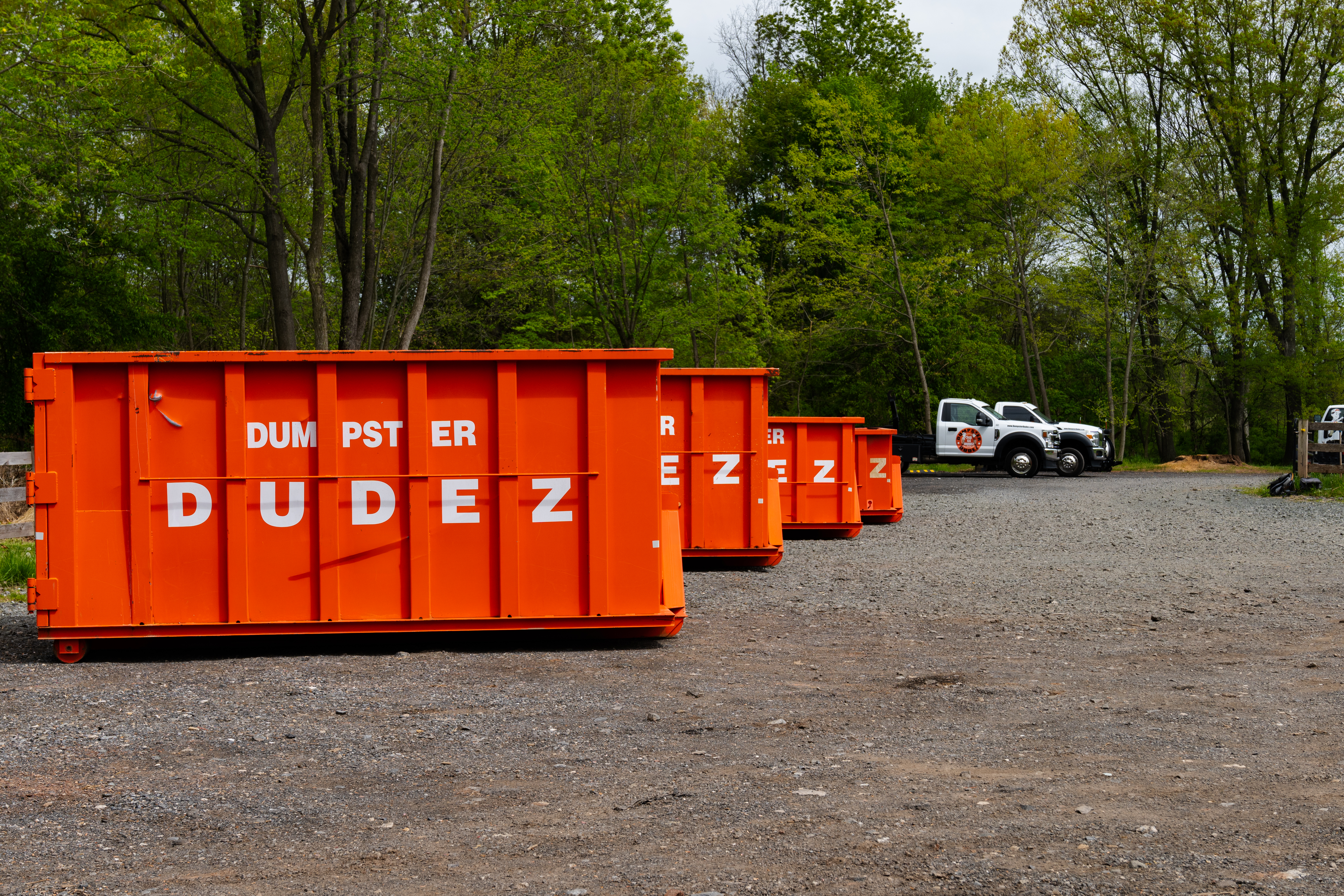 A row of different sized dumpster from Dumpster Dudez - contact us today for help choosing the right dumpster size!