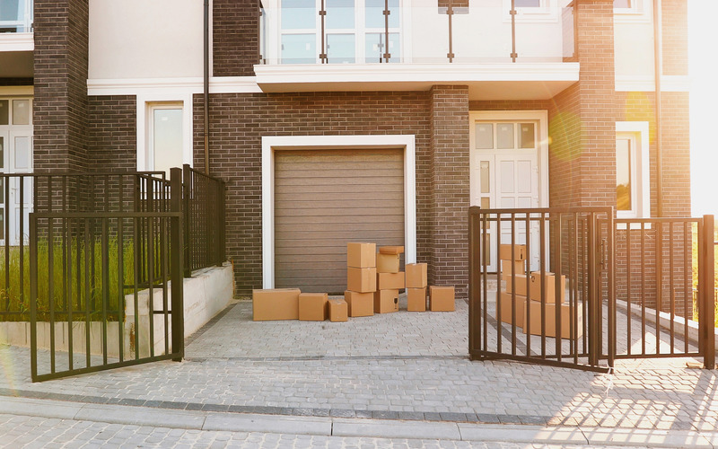 
				The exterior of a foreclosure property with boxes that need to be disposed of.
			